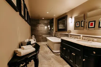 a bathroom with two sinks and a tub and a toilet at The Lion Inn in Chelmsford
