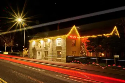 a lit up building with christmas lights on it at The Lion Inn in Chelmsford