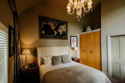 a bedroom with a bed and a chandelier at The Lion Inn in Chelmsford