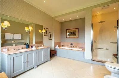 a bathroom with two sinks and a shower at The Jockey Club Rooms in Newmarket