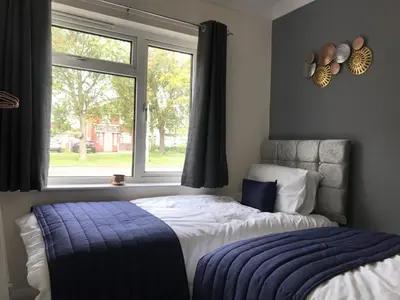 a bedroom with a bed and a window at The Avenues in Chelmsford