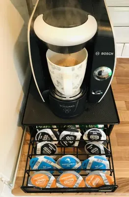 a coffee maker with a cup of coffee on a shelf at The Avenues in Chelmsford