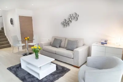 a living room with a couch and a table at Citystay Living - Park House in Cambridge