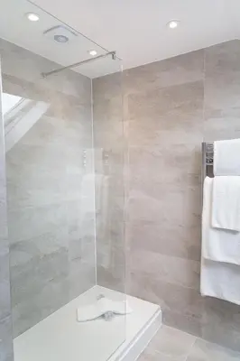 a bathroom with a shower with a glass door at Citystay Living - Park House in Cambridge