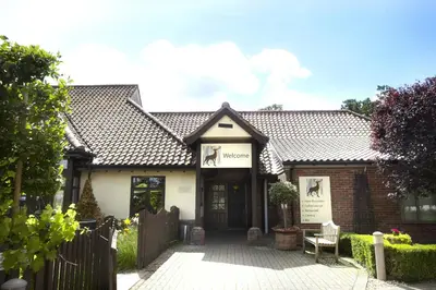a house with a gate in front of it at Breckland Lodge in Attleborough