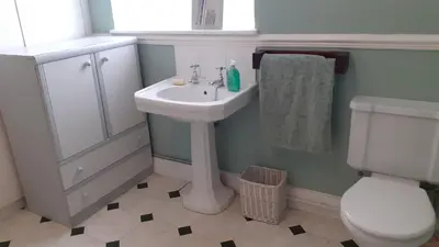 a bathroom with a white sink and a toilet at Kingsway Bed & Breakfast in Broxbourne