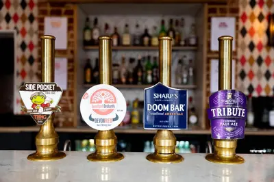a bar with four different types of alcohol bottles at The Coach House in Potton