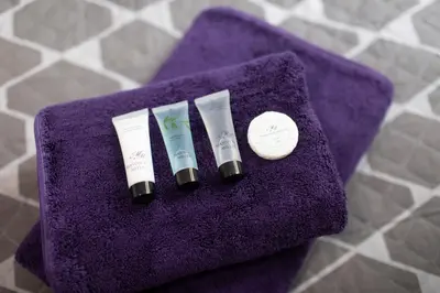three tubes of toothbrushes on a purple towel at The Norna in Cambridge