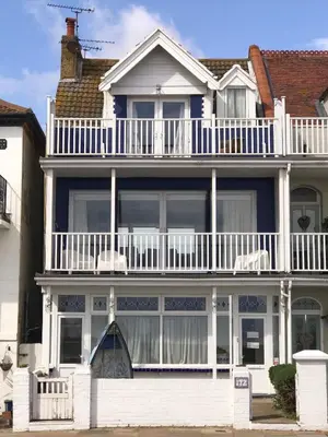 a large white house with a balcony on top of it at The Moorings B&B in Southend-on-Sea