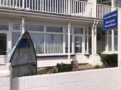 a house with a sign in front of it at The Moorings B&B in Southend-on-Sea