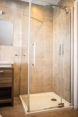 a shower with a glass door in a bathroom at The Oyster Smack in Burnham on Crouch