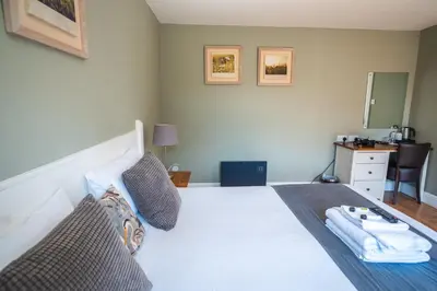 a bedroom with a large white bed with a mirror at The Oyster Smack in Burnham on Crouch