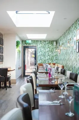 a dining room with long tables and chairs at The Oyster Smack in Burnham on Crouch