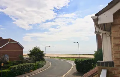 a road with a view of the beach at Seascape in Clacton-on-Sea