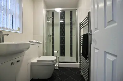 a bathroom with a shower and a toilet and a sink at Seascape in Clacton-on-Sea