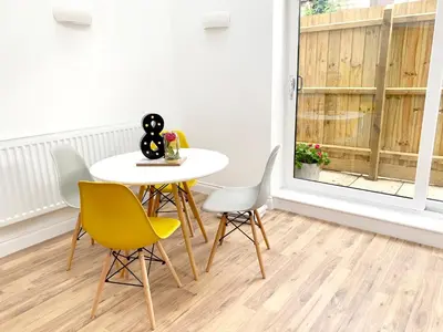 a dining room with a table and chairs and a window at The Birches in Cambridge