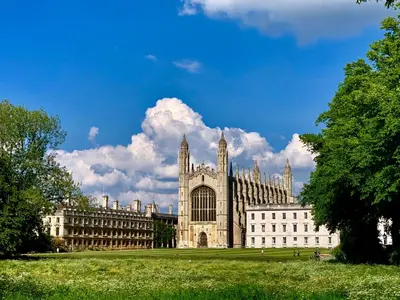 a large building in a field with a blue sky at The Birches in Cambridge