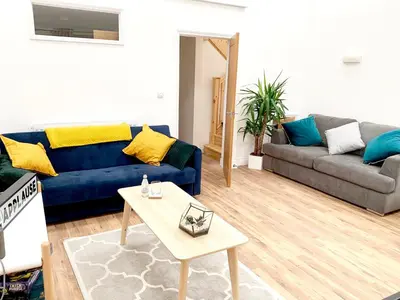 a living room with a blue couch and a table at The Birches in Cambridge