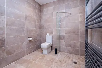 a bathroom with a toilet and a shower at Birch - Three Tuns Apartments - Pettistree, Wickham Market - by Aldeburgh Coastal Cottages in Pettistree