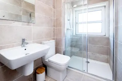 a bathroom with a toilet and a sink and a shower at Elm - Three Tuns Apartments, Pettistree, Wickham Market - by Aldeburgh Coastal Cottages in Pettistree