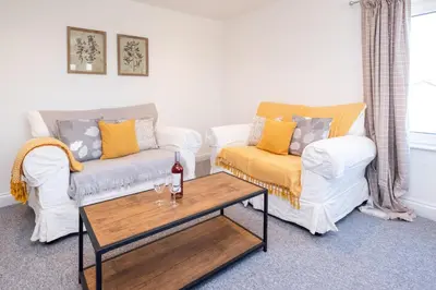 a living room with two couches and a coffee table at Elm - Three Tuns Apartments, Pettistree, Wickham Market - by Aldeburgh Coastal Cottages in Pettistree
