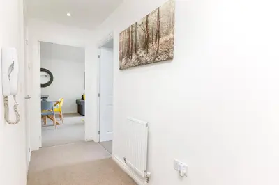 a room with a hallway with a painting on the wall at Hertford Serviced Apartments in Hertford