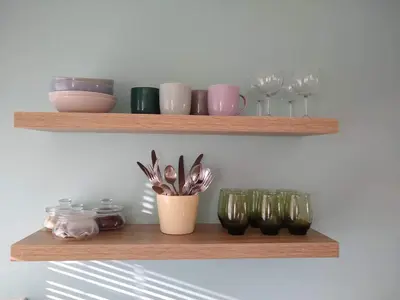 a shelf with bowls and glasses on it at The Annexe in Hawkedon