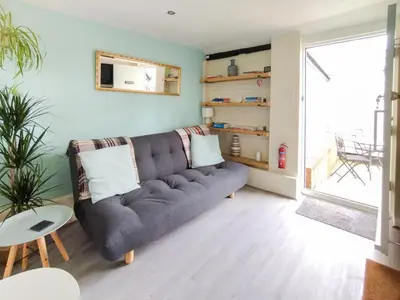 a living room with a couch and a table at The Annexe in Hawkedon