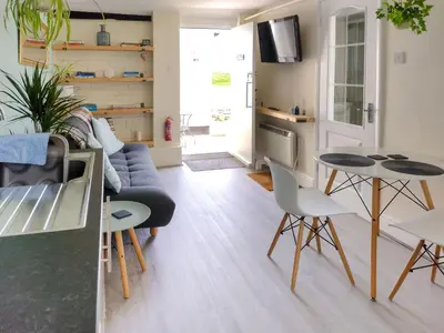 a living room with a couch and a table and chairs at The Annexe in Hawkedon