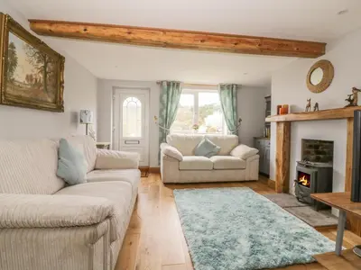 a living room with two couches and a fireplace at 2 Hillside Cottages in Ipswich