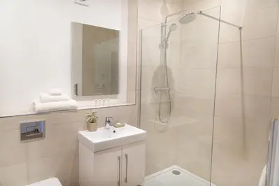 a bathroom with a shower and a toilet and a sink at Citystay Living - Franklin House in Cambridge