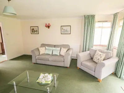 a living room with two chairs and a table at The Bothy in Eye