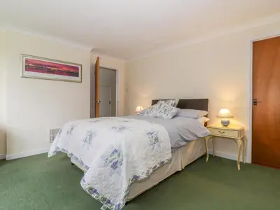 a bedroom with a bed and a table with a night stand at The Bothy in Eye