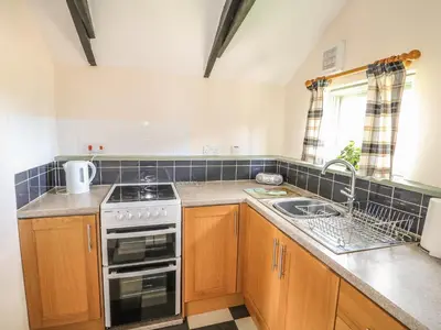 a kitchen with a stove and a sink at The Bull Pen in Eye