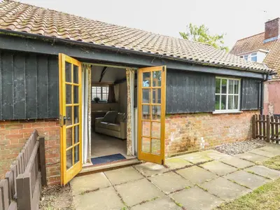 a extension to a house with yellow doors at The Bull Pen in Eye
