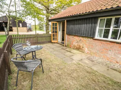 a table and chairs in the yard of a house at The Bull Pen in Eye