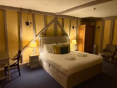 a bedroom with a bed and a desk and a chair at Black Buoy Inn in Wivenhoe