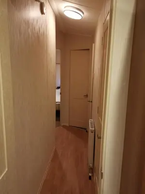 a hallway with a door and a room with a bed at Caledonian Caravan in Jaywick Sands