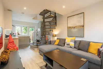 a living room with a couch and a table at Delightful CENTRAL Duplex - 2 Mins To Station in Cambridge