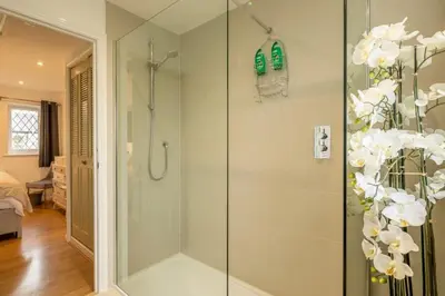 a shower with a glass door in a bathroom at Delightful CENTRAL Duplex - 2 Mins To Station in Cambridge