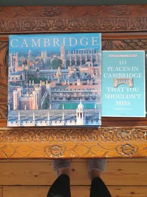 a person is standing over a table with a book at Harry's bed and breakfast in Cambridge