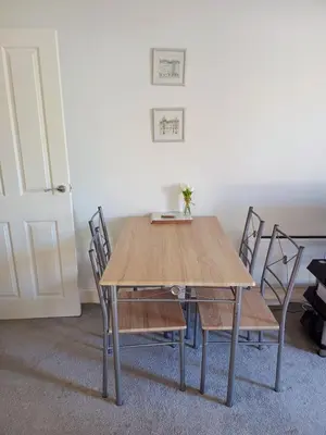 a dining room table with chairs and a wooden table at Luxury 2-Bed Flat Central Ipswich Parking in Ipswich