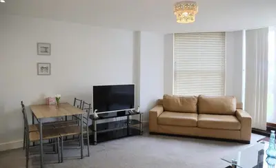 a living room with a couch and a table at Luxury 2-Bed Flat Central Ipswich Parking in Ipswich