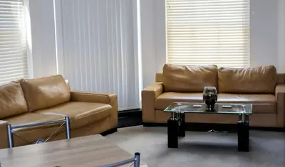 a living room with two couches and a coffee table at Luxury 2-Bed Flat Central Ipswich Parking in Ipswich