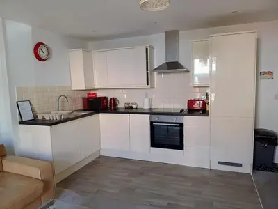 a kitchen with white cabinets and a counter top at Luxury 2-Bed Flat Central Ipswich Parking in Ipswich