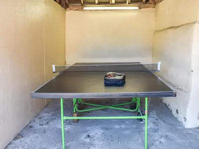 a ping pong table sitting in a room at Coachman's Cottage - Uk11449 in Mellis