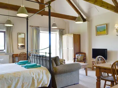 a bedroom with a bed and a chair and a table at The Studio-Uk11822 in Westleton