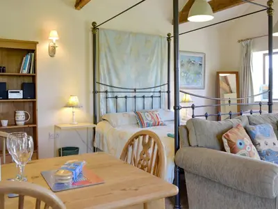 a living room with a bed and a table at The Studio-Uk11822 in Westleton