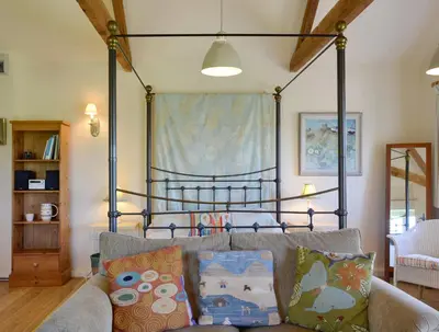 a bed in a living room with a couch at The Studio-Uk11822 in Westleton