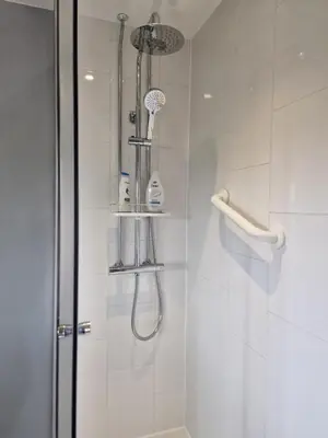 a bathroom with a shower with a shower head at Spring Paddocks B&B in Furneux Pelham